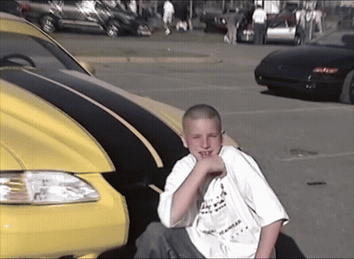 Boy In I Am A Los Angeles Shirt Next To Yellow Car GIF