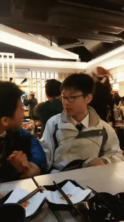 Boy In Jacket And Tie Talks To Another GIF