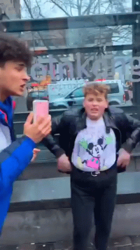 Boy In Mickey Mouse Shirt Taking Picture Of Another Boy GIF