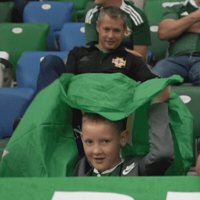 Boy In Nike Shirt Holding Green Cloth GIF