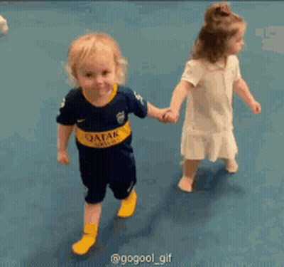Boy In Qatar Jersey Holding Hands GIF