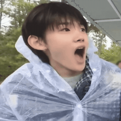 Boy In Raincoat Making Funny Face GIF