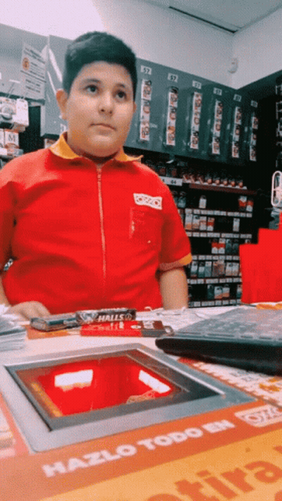 Boy In Red And Yellow Uniform In Front Of Machine Saying Hazlo Todo GIF