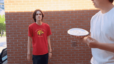 Boy In Red Eagles Shirt Throwing Plate Of Food GIF