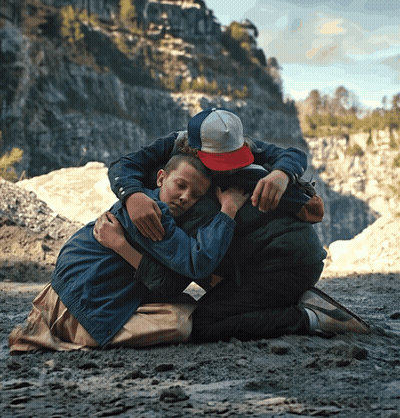 Boy In Red Hat Hugging Another Boy GIF
