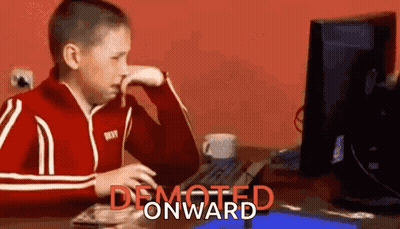 Boy In Red Jacket Sitting At Computer Desk GIF