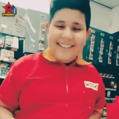 Boy In Red Shirt Smiling In Store GIF