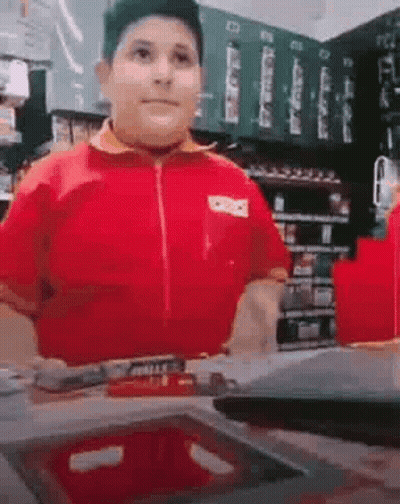 Boy In Red Shirt Standing In Store GIF