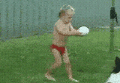 Boy In Red Swim Trunks Running Toward Ball GIF