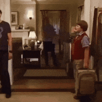 Boy In Red Vest Holding Suitcase GIF