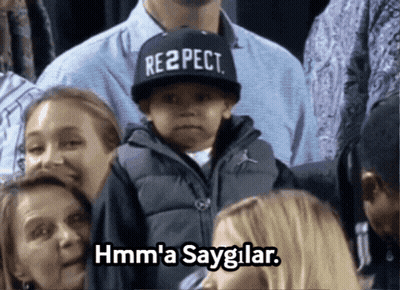 Boy In Respect Hat Sitting In Crowd GIF