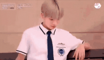 Boy In School Uniform Leaning On Wall GIF