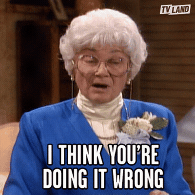 Boy In School Uniform Standing Before Flowers GIF