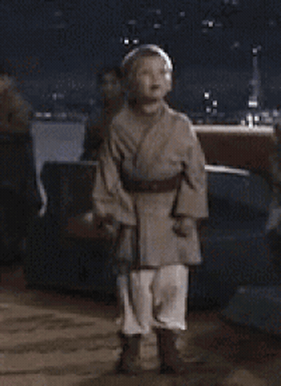 Boy In Star Wars Costume With Lightsaber GIF