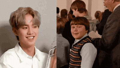 Boy In Striped Vest Smiling Next To Boy In White Shirt GIF
