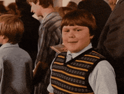 Boy In Striped Vest Standing In Crowd GIF
