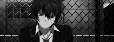 Boy In Suit Sitting In Front Of Fence GIF