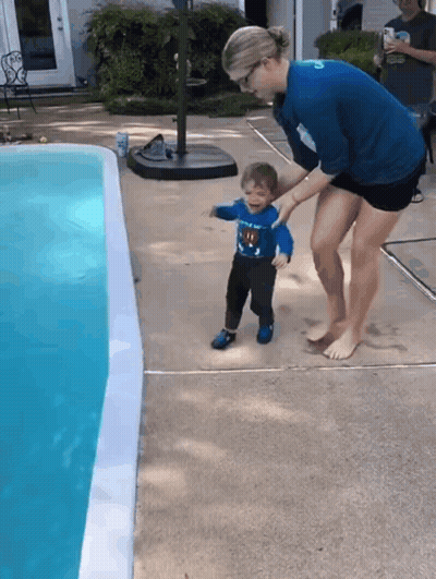 Boy In Superman Shirt Held By Woman GIF