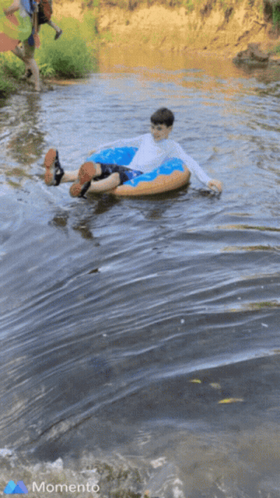 Boy In Tube In River With Momento GIF