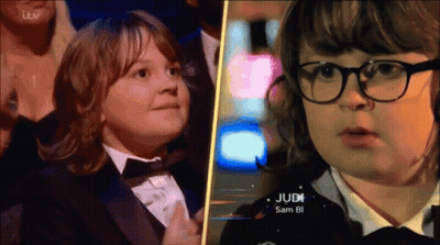 Boy in Tuxedo Next to Girl With Glasses