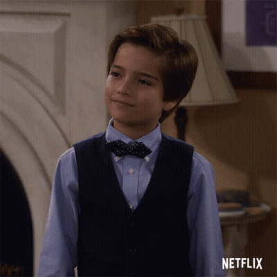 Boy In Vest And Bow Tie At Netflix Logo GIF