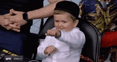 Boy In White Shirt And Black Hat Sitting GIF