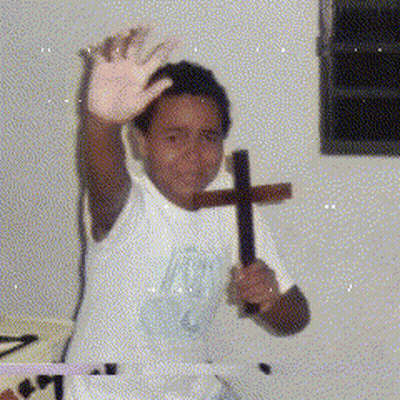 Boy In White Shirt Holding Cross GIF
