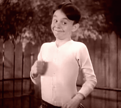 Boy In White Shirt Smiling At Fence GIF