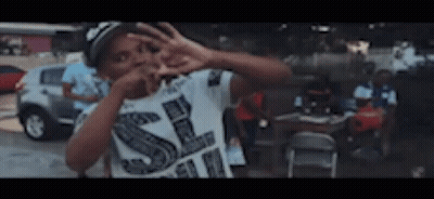 Boy In White Shirt With Letter S Making Peace Sign GIF