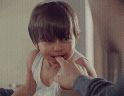 Boy In White Tank Top Biting Finger GIF