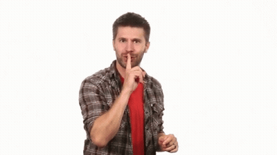 Boy In White Tank Top Making Shhh Sign GIF