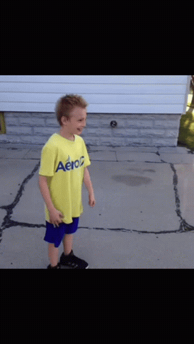 Boy In Yellow Aeropostale Shirt On Sidewalk GIF