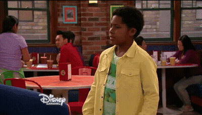 Boy In Yellow Jacket Standing In Diner With Disney GIF