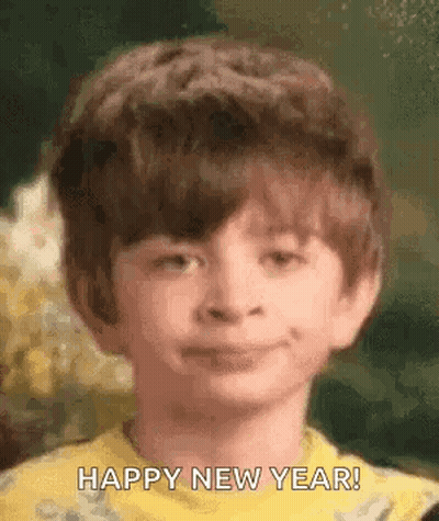 Boy In Yellow Shirt Saying Happy New Year GIF