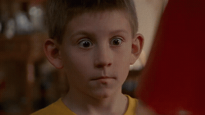 Boy In Yellow Shirt Standing In Kitchen GIF