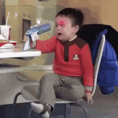 Boy In Yellow Shirt With Teddy Bear Eating Hamburger At McDonald's GIF