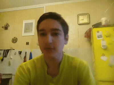 Boy In Yellow Shirt, Yellow Refrigerator, And Clock GIF