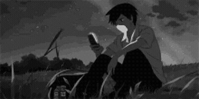 Boy Looking At Phone In Grass GIF