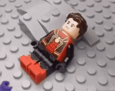 Boy Lying In Lego Bricks With Lego Sticker GIF