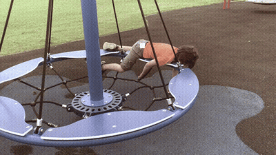 Boy Lying On Blue And Purple Merry Go Round GIF