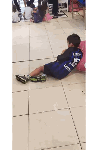 Boy Lying On Floor Wearing L Martinez Jersey Sticker