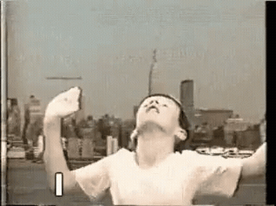 Boy On Rooftop Arms Outstretched Looking Up GIF