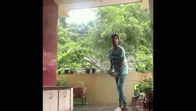 Boy Playing Cricket On Balcony GIF