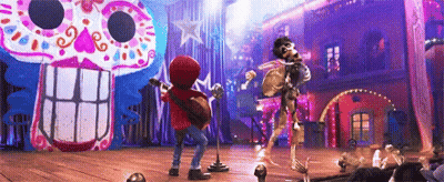 Boy Playing Guitar And Singing Into Microphone On Stage In Front Of Skeleton GIF