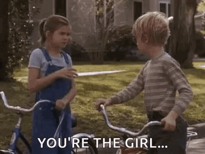 Boy Pointing At Girl On Bicycle GIF