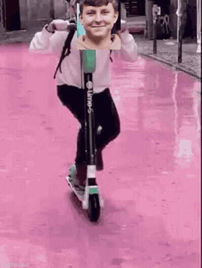 Boy Riding Scooter On Pink Street GIF