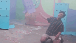 Boy Rolling On Floor Laughing GIF