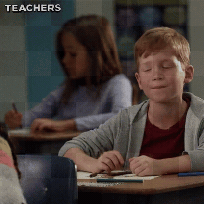 Boy Sitting At Desk Eyes Closed GIF
