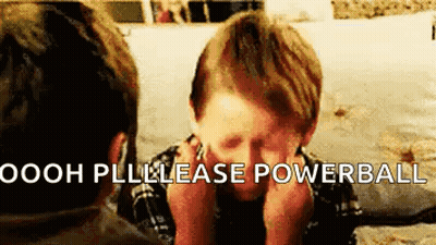 Boy Sitting At Table With Hands On Face GIF