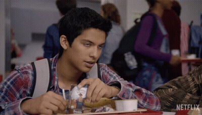 Boy Sitting At Table With Netflix Logo GIF